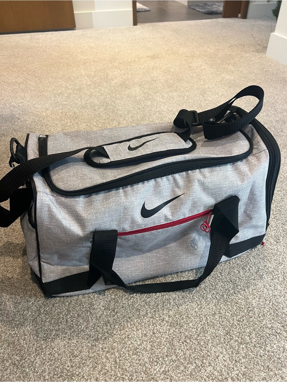 Nike Gray Duffel Bag with Black Trim and Red Accent